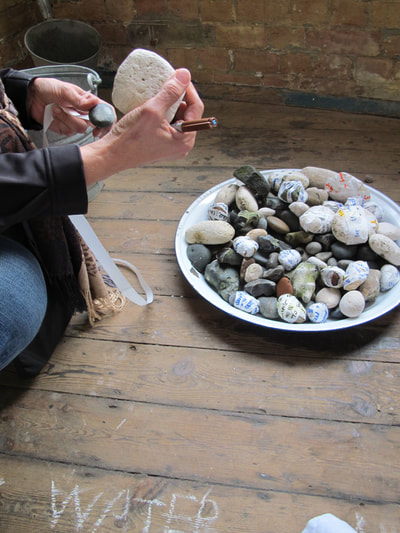 Performance and public engagement with Kerry Morrison for Not a Drop.  Thames River stones gathered and trundled through the streets of London to a place where the public wrote their personal messages to the river onto dissolving paper, and attached them to river stones, which were then returned to the water.